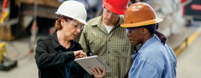 Three people discusssing while look at the screen