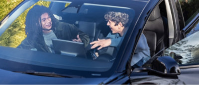 Two people sitting in the car and discussing
