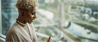 A woman with curly hair working on the tablet