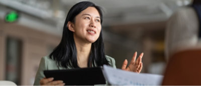 Woman holding tablet and speaking