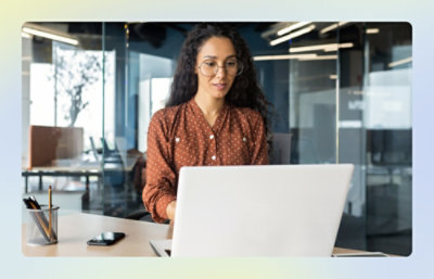 Person working on a laptop in a modern office setting.