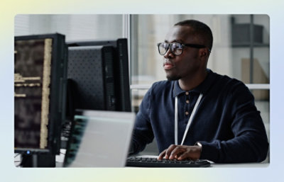 Developer working at a multi‑monitor workstation.