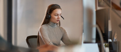 Woman sitting down with a headset on