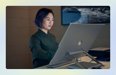 A woman sitting at a desk using a computer.