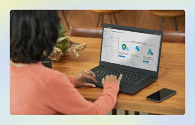 A person sitting at a table using a laptop.