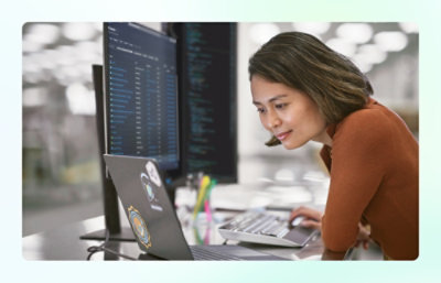 A woman is looking at the laptop.
