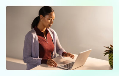 A woman is looking at the laptop.