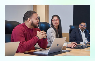 Three people in a meeting room