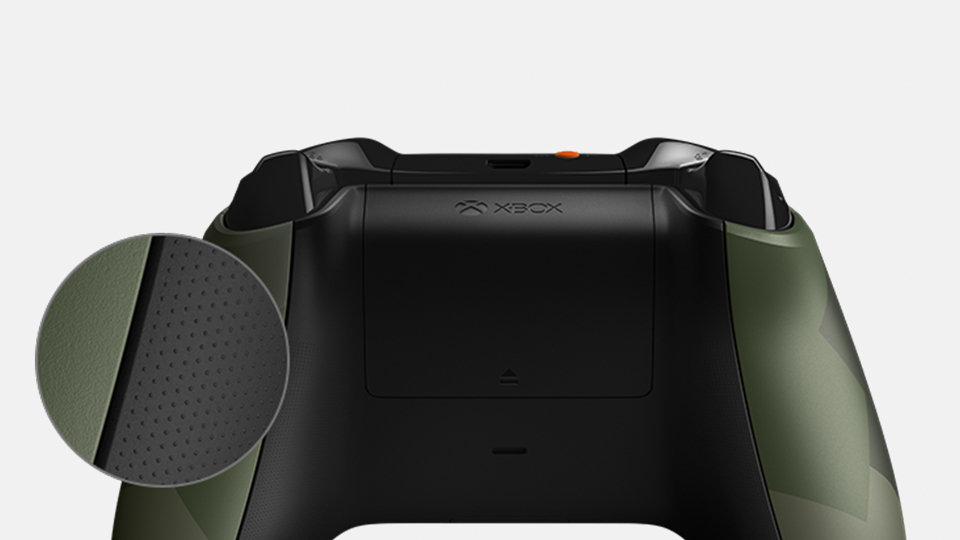 Xbox controller with a dark green modern camo design.