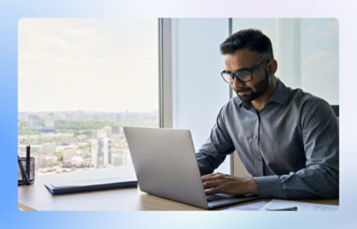 Man working on laptop in high rise office building
