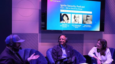 A woman and two men sitting in chairs.