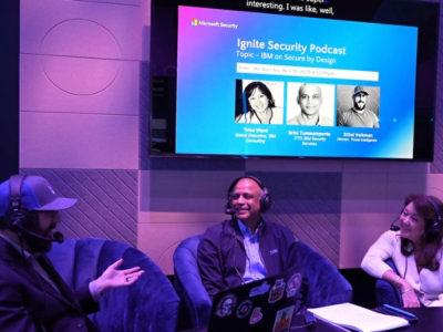 A woman and two men sitting in chairs.