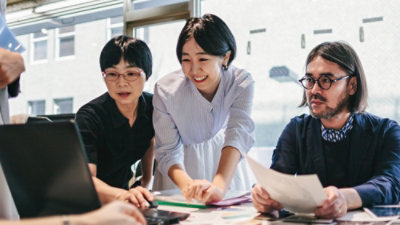 A group of people looking at papers.
