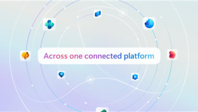 Three colleagues in discussion around a table.