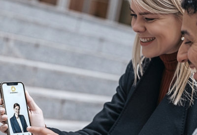 Two people viewing a profile on a smartphone