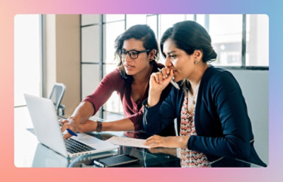 Two women looking at a laptop.