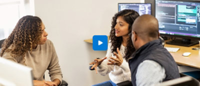 Team brainstorming in front of computer screens