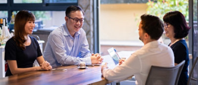 Two man and two women sitting on the table and discussing to each other