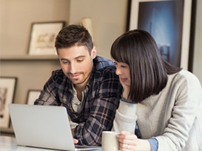 A men and women looking at a laptop