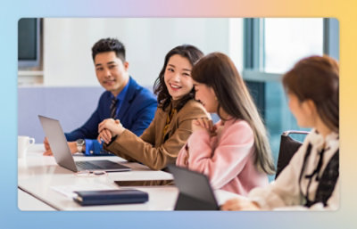 A group of people working on a desk.