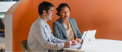 A men and women working on a laptop