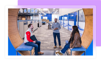 A group of people sitting in chairs in a room.