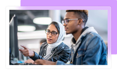 A man and woman looking at a computer screen.