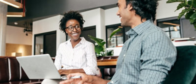 Team working together in an open office with multiple desks and monitors