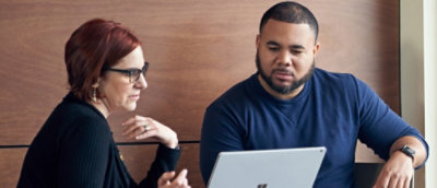 A man and a woman looking at a laptop.