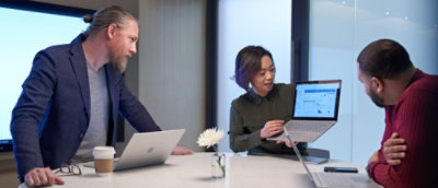A man and woman looking at a laptop.