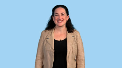 Women in brown jacket with blue background