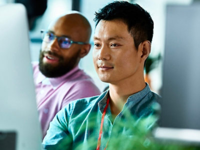 A group of people sitting and looking at monitor