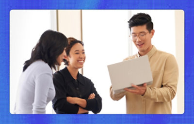 A group of three people discussing with laptop