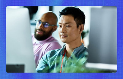 Two men looking at the screen and smiling