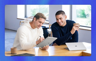 A man and woman looking at a computer screen.