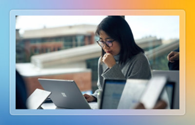 Person working on a laptop with multiple monitors