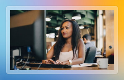 A person sitting at a desk using a computer.