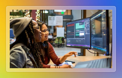 Team collaborating around a table with documents and a laptop.