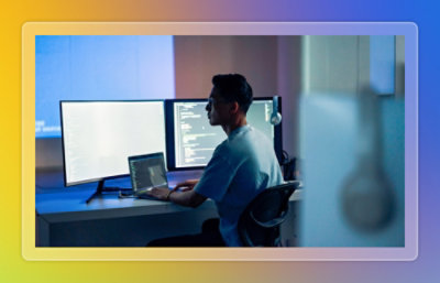 A person sitting at a desk using a laptop.
