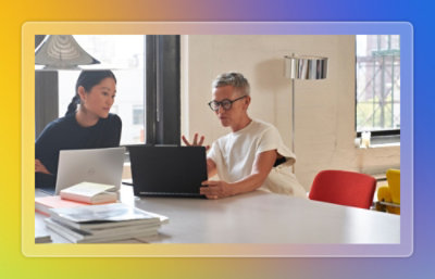 People talking and looking at laptop