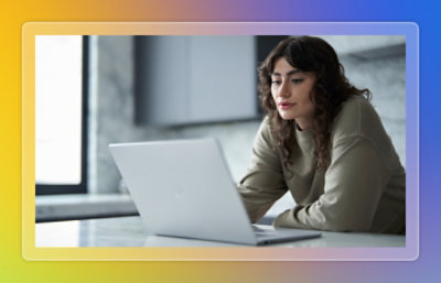 A woman looking at a laptop.