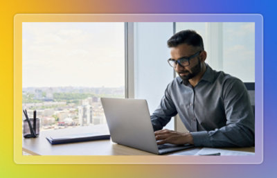A person sitting at a desk using a laptop.
