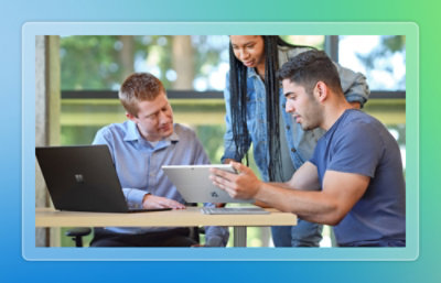 A group of people looking at a tablet.