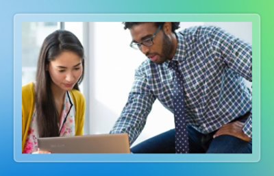 Two people looking at the laptop.