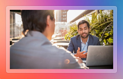 Men on laptop conversing