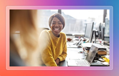 Two employees discussing while being quite happy.