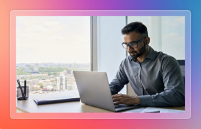 A person sitting at a desk using a laptop.