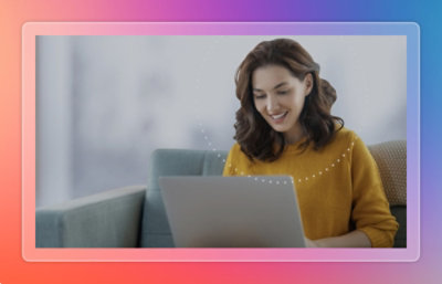 A person sitting on a couch using a laptop.