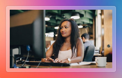 A person sitting at a desk using a computer.