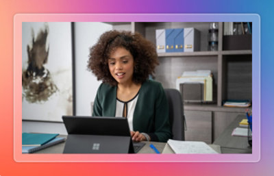 Three employees discussiing something while looking at a laptop.